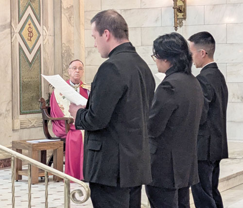 With Archbishop Charles C. Thompson looking on during a Vespers liturgy on March 15 in the Blessed Sacrament Chapel of SS. Peter and Paul Cathedral in Indianapolis, Deacon Samuel Hansen, left, Deacon Timothy Khuishing and Deacon Khaing Thu declare that they are freely seeking ordination as priests. The three transitional deacons will be ordained priests on June 6 in the cathedral. (Photo by Sean Gallagher)