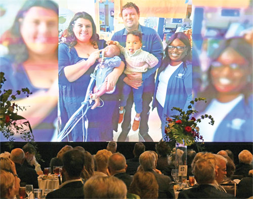 In this photo displayed during St. Elizabeth Catholic Charities&rsquo; annual Giving Hope-Changing Lives gala on April 16, Stefanie Lowery, right, then-adoption director for the New Albany-based agency&rsquo;s Adoption Bridges of Kentuckiana, poses with Mary Beth and Carl Clark and their two adopted sons&mdash;Gabriel held by Mary Beth and Wiatt held by Carl&mdash;in the neonatal intensive care unit of Norton&rsquo;s Children&rsquo;s Hospital in Louisville, Ky., in 2024. (Photo by Natalie Hoefer)