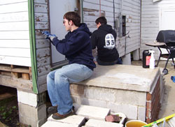 Youth working on a house