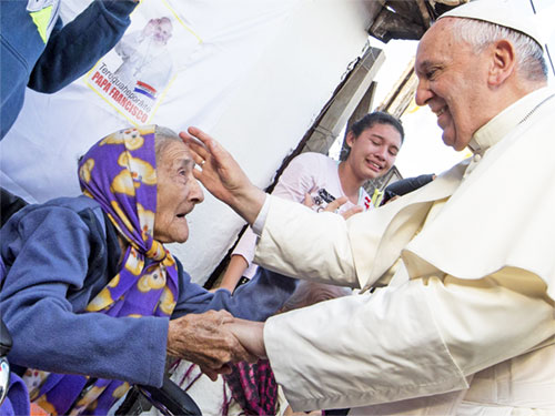Pope Francis greets an elderly woman as he meets with people of the Banado Norte neighborhood in the Chapel of St. John the Baptist in Asuncion, Paraguay, July 12, 2015. Pope Francis, formerly Argentine Cardinal Jorge Mario Bergoglio, died April 21, 2025, at age 88. (CNS photo/Paul Haring)