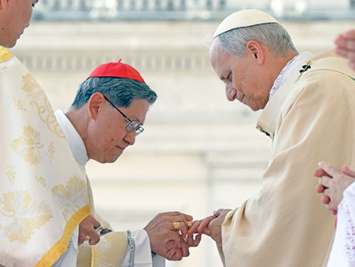 Pope Leo XIV receives the fisherman's ring, symbolizing his role as successor to St. Peter, from Filipino Cardinal Luis Antonio Tagle during the pope's inauguration Mass in St. Peter's Square May 18, 2025. (CNS photo/Vatican Media)