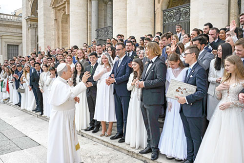 Pope Leo XIV greets newlywed couples who came for a blessing at his weekly general audience in St. Peter’s Square at the Vatican on Nov. 19. (CNS photo/Vatican Media)