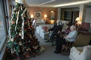St. Paul Hermitage residents Juanita and Jim McNulty talk with Benedictine Sister Mary Nicolette Etienne on Dec. 12 in the lounge at the sisters’ home for the elderly in Beech Grove. (Photo by Brandon A. Evans)
