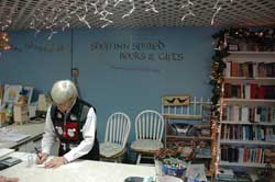 Benedictine Sister Mary Luke Jones, administrator of the Benedict Inn Retreat and Conference Center in Beech Grove, does paperwork on Dec. 12 in the center’s Shop Inn Spired Books and Gifts. The center is an ecumenical ministry of Our Lady of Grace Monastery in Beech Grove.