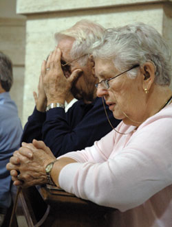 Patricia and Raymond Mayer, members of St. Roch Parish in Indianapolis, pray after receiving Communion during a pilgrimage Mass celebrated on Oct. 14 at St. Mary Major Basilica in Rome.