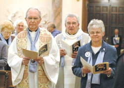 Father Bernard Head, left, former chaplain of the Sisters of Providence, processes into the Church of the Immaculate Conception with Father Daniel Hopcus, chaplain of the congregation, and Providence Sister Denise Wilkinson, general superior, on Oct. 22 for the celebration of Foundation Day and the canonization of St. Theodora Guérin.