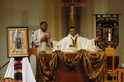 Franciscan Father Juan Carlos Ruiz-Guerrero, associate pastor of St. Patrick Parish in Indianapolis, celebrates the eucharistic liturgy with Divine Word Father Stephan Brown, left, pastor of St. Rita Parish in Indianapolis and the homilist for the Mass, during the third annual celebration of the feast of St. Martin de Porres on Nov. 3 at St. Monica Church in Indianapolis. Eight other priests, including Msgr. Paul Koetter, pastor of St. Monica Parish, concelebrated the liturgy.