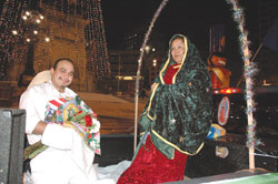 Julio Roman, left, portrays St. Juan Diego and Irma Patilla is dressed as Our Lady of Guadalupe during a vigil procession on Dec. 11, 2005, around Monument Circle in downtown Indianapolis. The procession concluded at nearby St. Mary Church in Indianapolis, where Father Michael O’Mara, pastor, celebrated a Mass in honor of Our Lady of Guadalupe. (File photo by Mary Ann Wyand) 