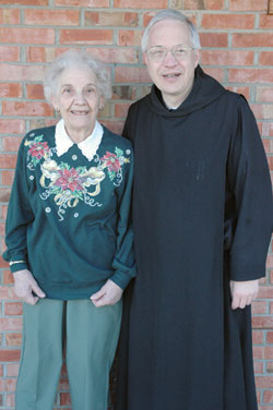 Dorothy Colgan poses for a photograph with one of her sons, Benedictine Father Tobias Colgan, prior of Saint Meinrad Archabbey, on Jan. 2 outside her apartment in St. Meinrad.
