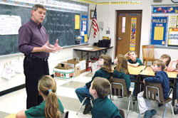 Deacon candidate Mike Gardner, a member of Prince of Peace Parish in Madison, discusses the diaconate on Nov. 16 with third-graders at Pope John XXIII School in Madison.