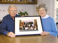 Ed and Val Fillenwarth hold a family portrait of their seven children and 17 grandchildren that is displayed in their Indianapolis home.