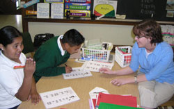 Fourth-grader Regina Casas and fifth-grader Arturo Aguilar receive tutoring in English during teacher Laura Mull’s English as a New Language class in May 2006 at St. Philip Neri School in Indianapolis. (File photo by Mike Krokos) 