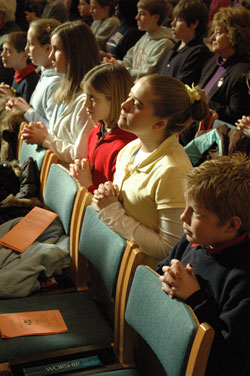 Several students from St. Gabriel School in Connversville kneel in prayer during the Jan. 31 Catholic Schools Week Mass at SS. Peter and Paul Cathedral in Indianapolis. From left, they are fifth-graders Victor Riedman and Madison Fain, sixth-graders Hannah Shelton, MIssy Schnelle and Mackenzie Fuller, and fifth-grader Jacob Hackleman. (Photo by Sean Gallagher)