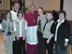Members of Girl Scout Troop 1602, from left, Kaela Clemons, Kathleen Coyle, Lauren Lucas and Julianna Knight, pose with Mary Lynn Cavanaugh, right, the director of religious education at St. Mark the Evangelist Parish in Indianapolis, Archbishop Daniel M. Buechlein and Father Jonathan Meyer after the Feb. 11 Scout awards ceremony. The troop received the Spirit Alive Award.