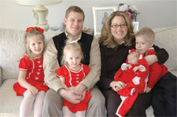 St. Simon the Apostle parishioners Chris and Paje Felts of Indianapolis pose for a family portrait on Feb. 10 with their 5-year-old twins, Madeline, left, and Patrick, right, their 2-year-old daughter, Jacqueline, and 10-week-old daughter, Anne Therese, who is named for St. Theodora Guérin.