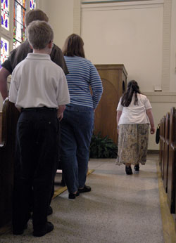 People wait in line for confession on March 25 at Holy Rosary Church in Indianapolis.