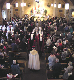 Msgr. Joseph F. Schaedel, archdiocesan vicar general, and several members of the Knights of Columbus process into St. Michael the Archangel Church in Indianapolis on April 3, 2005—the day after the death of Pope John Paul II—for the start of a Divine Mercy Sunday prayer service at the Indianapolis West Deanery parish.