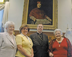 Standing with Archbishop Daniel M. Buechlein in front of a portrait of Bishop Francis Silas Chatard in the rectory of SS. Peter and Paul Cathedral in Indianapolis are, from left, the first three people to complete the archdiocesan Ecclesial Lay Ministry formation program: Sandra Cook, Connie Sandlin and Margaret Nelson.