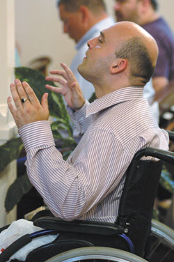 Francis McDermott, a member of St. Austin Parish in Ormskirk, Lancashire, in northwestern England, praises God and Mary in prayer as he listens to Holy Trinity parishioner Kay DeHart sing “Ave Maria” during Father Rick Nagel’s first Mass of Thanksgiving on June 3 at Holy Trinity Church in Edinburgh.