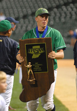 Senior Mark Branigan clutches the ISHAA Class 4A state championship trophy after Cathedral High School beat Kokomo 7-2 on June 16. Mark is the son of Roger and Barbara Branigan, who are members of St. Pius X Parish in Indianapolis. (Submitted photo by Doug McSchooler) 