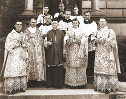 After celebrating his first Mass on June 7, 1936, then Father Richard Kavanagh, third from left in the front row, poses in front of the rectory of SS. Peter and Paul Cathedral in Indianapolis. Assisting him at the Mass were, from left, in the front row, Benedictine Father Bernardine Shine, Father Bernard Sheridan, Msgr. Raymond Noll and Father Barrett Tieman, and from left, in the second row, Fathers James Hickey, John Lynch and George Dunn. In the third row were seminarians Joseph Dooley, Charles Koster and an unnamed altar server.