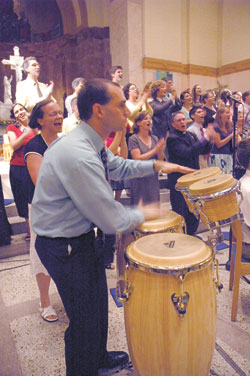 Joshua Stagni, the principal percussionist for the Notre Dame Folk Choir, plays the drums while the choir sings during the ensemble’s July 10 concert at SS. Peter and Paul Cathedral in Indianapolis. The concert was a part of the July 9-13 convention of the National Association of Pastoral Musicians.