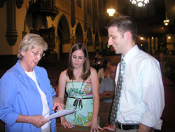 As the wedding hostess at St. John the Evangelist Parish in Indianapolis, Eileen Ahrens gives instructions to Lauren Rossier and Jeff Bodkin during the rehearsal for their June 29 wedding.