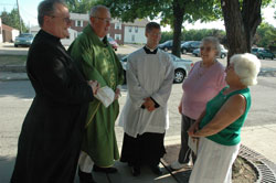 Following the conclusion of a July 14 Mass in English at Our Lady of the Most Holy Rosary Church in Indianapolis, Priestly Fraternity of St. Peter Father Michael Magiera, left, associate pastor of the parish, talks with parishioner Josephine Lombardo, at right. Also present were, second from left, Msgr. Joseph F. Schaedel, pastor of the parish; seminarian Sean Danda and parishioner Mary Jo Buker.