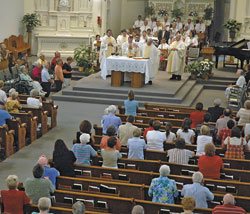 Above, members of parishes in the Seymour Deanery kneel in prayer during an Aug. 28 Mass in honor of St. Theodora Guérin for the Seymour Deanery at Prince of Peace Church in Madison.