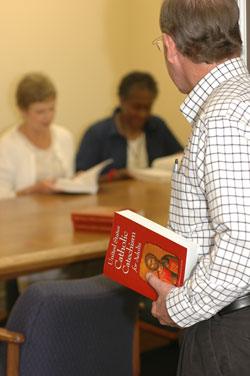 Parishes across the archdiocese are using the United States Catholic Catechism for Adults in adult faith formation groups, youth ministry and the Rite of Christian Initiation of Adults program to help nurture the faith of its members, both young and old. (Photo illustration by Brandon A. Evans) 