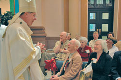 Archbishop Daniel M. Buechlein greets St. Mark the Evangelist parishioners Donald and Ruth Allen of Indianapolis during the 23rd annual archdiocesan Golden Wedding Anniversary Mass on Sept. 16 at SS. Peter and Paul Cathedral in Indianapolis. The Allens have been married for 67 years.