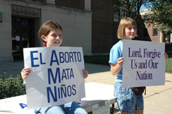St. Joan of Arc parishioners Abby Schneider, left, and Patty Yeadon of Indianapolis participate in the Central Indiana Life Chain on Oct. 1, 2006, on North Meridian Street in front of the Archbishop Edward T. O’Meara Catholic Center. Yeadon volunteers as a pro-life sidewalk counselor outside abortion clinics throughout the year. Life Chains are scheduled on Respect Life Sunday on Oct. 7 throughout the state. (File photo by Mary Ann Wyand) 