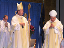 Archbishop Daniel M. Buechlein offers the closing prayer at Mass during the Indiana Catholic Men’s Conference on Sept. 22. To his right is Denver Archbishop Charles J. Chaput, who was the homilist for the Mass.