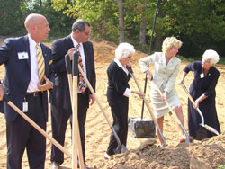Numerous dignitaries share ground­breaking duties for The Villas at Guérin Woods on Sept. 18. From left are Stephen Smith, director of the Division on Aging of the Indiana Family and Social Services Administration; New Albany Mayor James Garner; Georgetown resident Scyble Payne; Lt. Gov. Becky Skillman; and Providence Sister Barbara Ann Zeller, president of Guérin Inc. (Photo by Patricia Happel Cornwell) 	