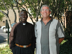 Sudanese Father Alfred Loro Caesar, left, and Comboni Father Michael Barton pose for a photograph on Aug. 7 outside the Archbishop O’Meara Catholic Center in Indianapolis.	