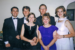 Starting from humble means that raised $60 and 40 gifts 10 years ago, six friends have continued to plan the Cadeaux Ball, a Christmas fundraiser that collected more than 400 gifts and $30,000 for Catholic Charities Indianapolis last year. Pictured, from left, at the first annual ball in 1997 are Jim Hardee, John Bradshaw, Lizabeth Bradshaw, Father Patrick Beidelman, Kristina Miller and Sarah Otte. (Submitted photo)	