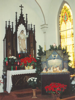 This historic Nativity set was photographed in front of the statue of St. Joseph holding the Christ Child at St. Patrick Chapel in Madison. (Submitted photo) 