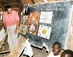 Comboni Father Michael Barton teaches Sudanese children about the Catholic faith at a Comboni primary school in southern Sudan in this file photo published on Oct. 18, 2002. He grew up in St. Therese of the Infant Jesus (Little Flower) Parish in Indianapolis. A new Internet blog publicizes his missionary work in East Africa. (Submitted photo) 