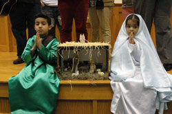 Jason Figueroa, left, and Amber Tlaxcala portray Joseph and Mary as part of the posada on Dec. 23 at St. Monica Parish in Indianapolis. (Photo by Mary Ann Wyand) 