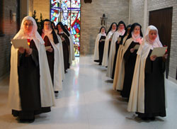 Discalced Carmelite Sisters Susanna Choi, left, and Mary Joseph Nguyen, who are novices, lead an Advent ­procession of the nuns at the Monastery of St. Joseph in Terre Haute in December. (Submitted photos/Carmel of Terre Haute) 