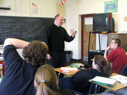 Father Bill Williams, chaplain at Father Thomas Scecina Memorial High School in Indianapolis, speaks with one of his religion classes at the school about vocations on Jan. 15. (Photo by Sean Gallagher) 