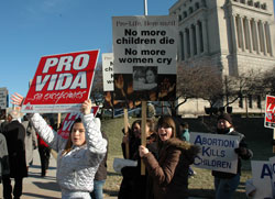 Teenagers carry pro-life signs during the Right to Life of Indianapolis Memorial Walk on Jan. 27 in downtown Indianapolis. The memorial prayer service and walk commemorated the lives of more than 48 million unborn babies killed in abortions in the U.S. since 1973. (Photo by Mary Ann Wyand)	
