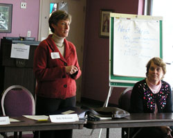 Holly McKiernan, senior vice president and chief counsel for Lumina Foundation and a member of the Catholic Community Foundation board of trustees, left, leads the facilitation process for the archdiocese’s strategic planning meeting held on Feb. 14 at Our Lady of Fatima Retreat House in Indianapolis. Connie Zittnan, director of Mother Theodore Catholic Academies, listens to her presentation. (Photo by Mike Krokos) 