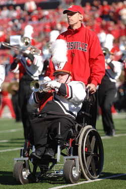 Patrick John Hughes and his son, Patrick Henry Hughes, perform as part of the University of Louisville marching band during halftime at a 2006 home football game. (Photo by Tom Fougerousse/University of Louisville) 