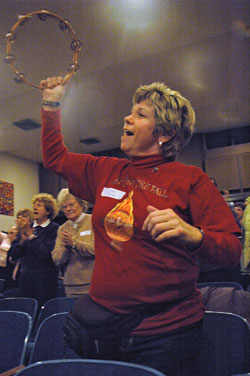 Karen Kamphaus, a member of St. Nicholas Parish in Ripley County, plays a tambourine during a praise and worship song on March 1 during a conference on the Holy Spirit and evangelization sponsored by her parish and held at Batesville High School in Batesville. (Photo by Sean Gallagher) 