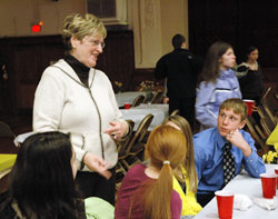 Annette “Mickey” Lentz talks with students at the annual A Promise to Keep: God’s Gift of Human Sexuality awards luncheon on March 6 at the Archbishop O’Meara Catholic Center in Indianapolis. The archdiocesan volunteer peer mentor chastity program is in its 14th year. (Photo by Mary Ann Wyand) 
