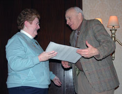 Gabriel Project of Indiana director Eileen Hartman of St. Bartholomew Parish in Columbus presents a Catholic Life Network Pro Vita Award to Robert Rust of Greensburg, who is a member of St. John the Evangelist Parish in Enochsburg, during the fourth annual Catholic Pro-Life Dinner on March 8 in Indianapolis. Five other pro-life volunteers also were honored during the program. (Photo by Mary Ann Wyand) 
