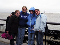 Marian College students Carrie Shelhart, from left, Staci Striegel, Sarah McEwan and Katie Louden spent four days in New York in March to participate in a United Nations study session called “Women as Peacemakers.” The Statue of Liberty can be seen in the background. (Submitted photo) 