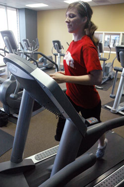 Julie Burns, a member of St. Joan of Arc Parish in Indianapolis, runs on a treadmill at her apartment complex in Indianapolis while training for the One America 500 Festival Mini-Marathon scheduled on May 3. She will be a member of the archdiocese’s “Run for Vocations” team. (Photo by Sean Gallagher) 