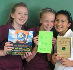 From praying for the Earth to helping people in other countries, Catholic school students have used different methods to show their growing interest in caring for the world. At St. Barnabas School in Indianapolis, from left, Morgan Barrett, Shelby Hurrle and Sophia Milto are among the sixth-grade students who have put their reading about the environment into practice. (Photo by John Shaughnessy) 